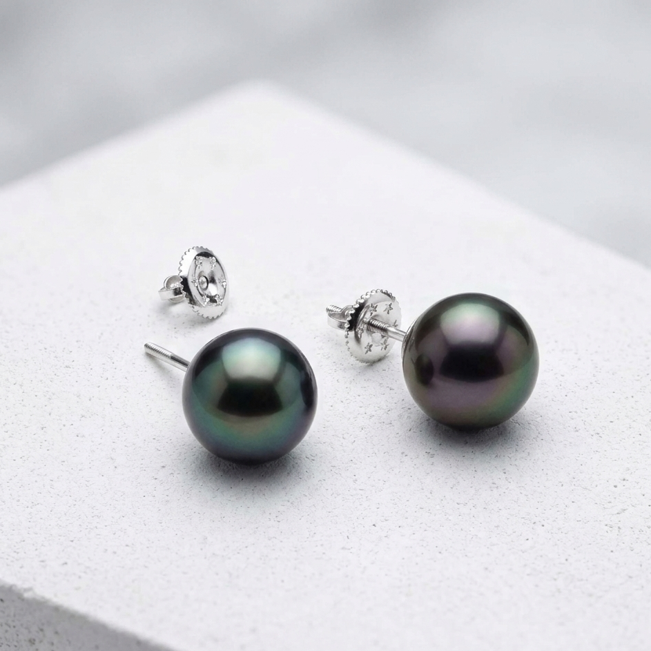 Pair of black pearl earrings on a white background