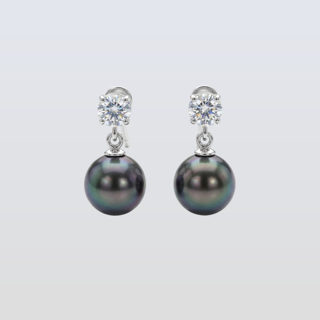 Pair of pearl earrings with clear gemstones on a light gray background