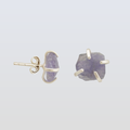 Pair of earrings with purple stones and gold accents on a light gray background