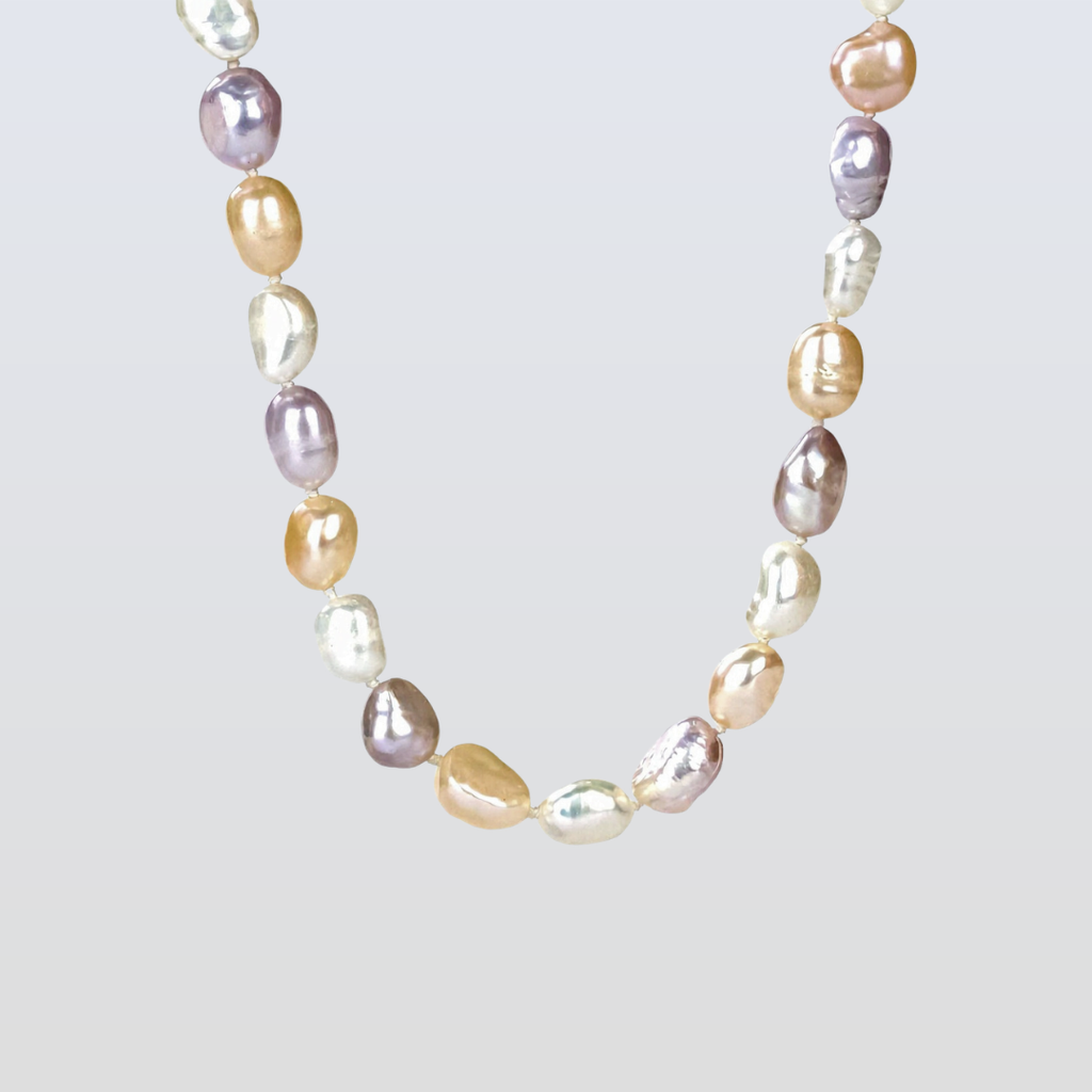 Necklace with multicolored pearls on a light gray background