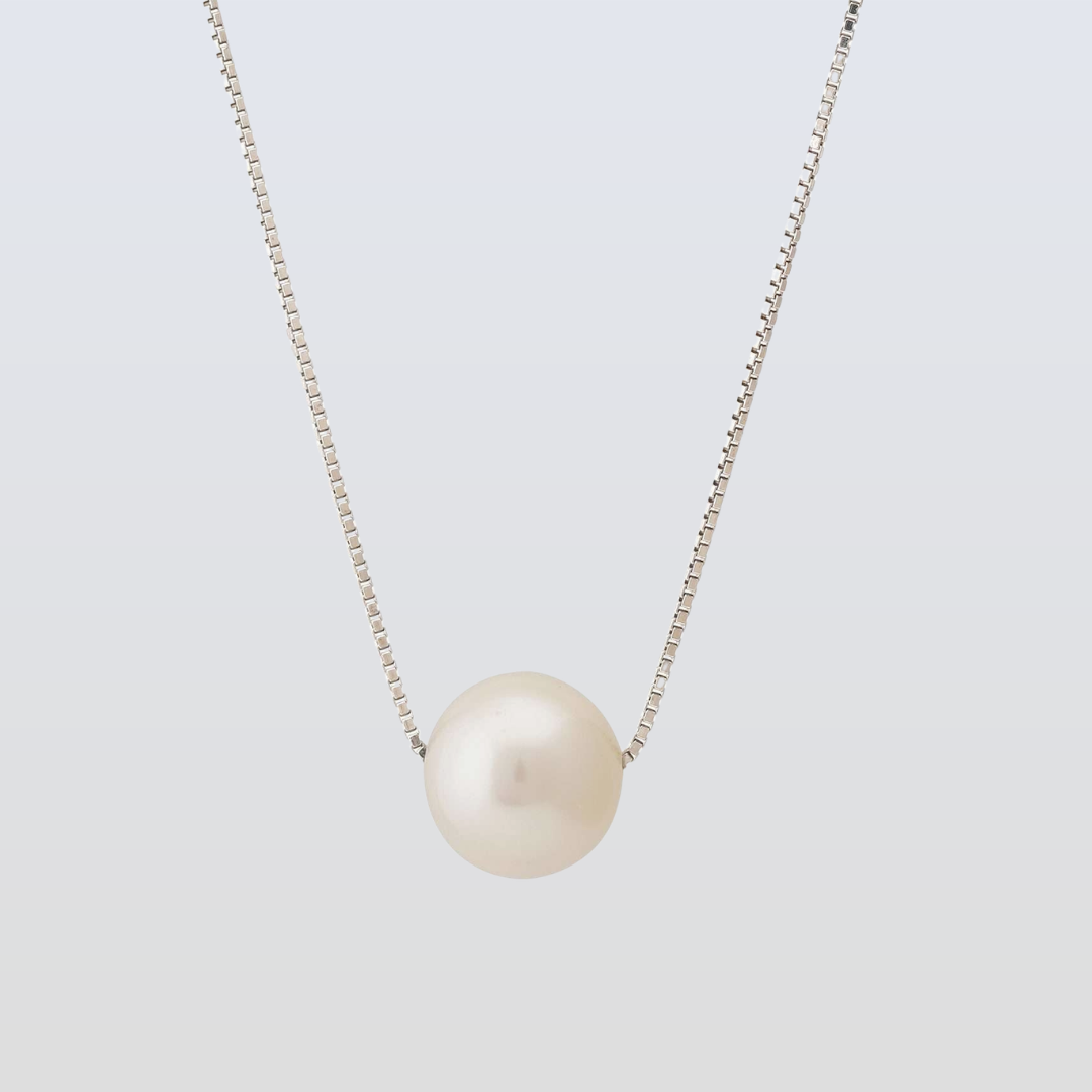 Pearl necklace on a light gray background