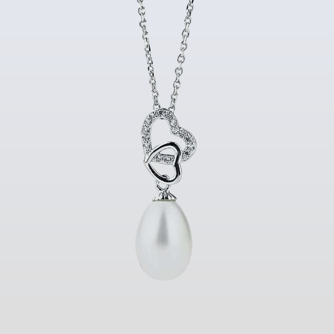 Pearl necklace with a heart-shaped pendant on a light gray background