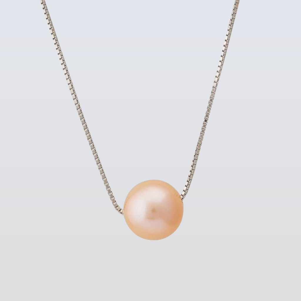 Pearl necklace with a light pink pearl on a thin chain against a light gray background