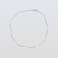 Necklace with small beads on a light gray background