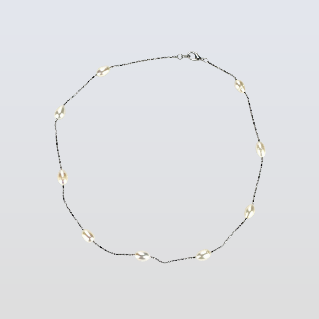 Necklace with small beads on a light gray background