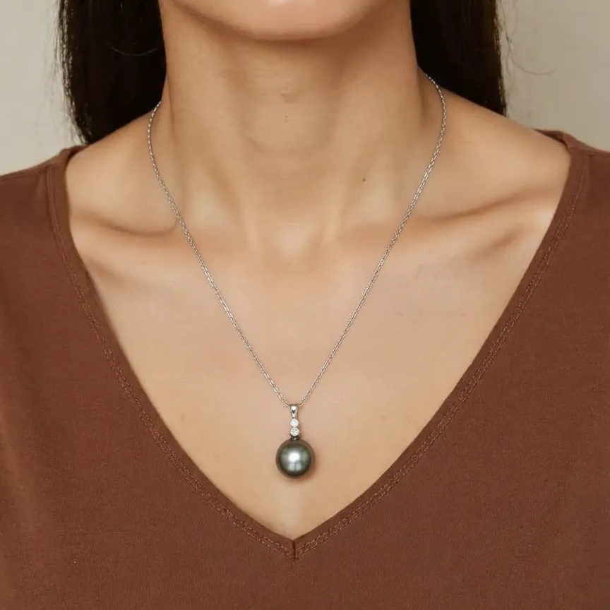 Woman wearing a necklace with a pendant against a neutral background