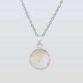 Necklace with a round pendant on a light gray background