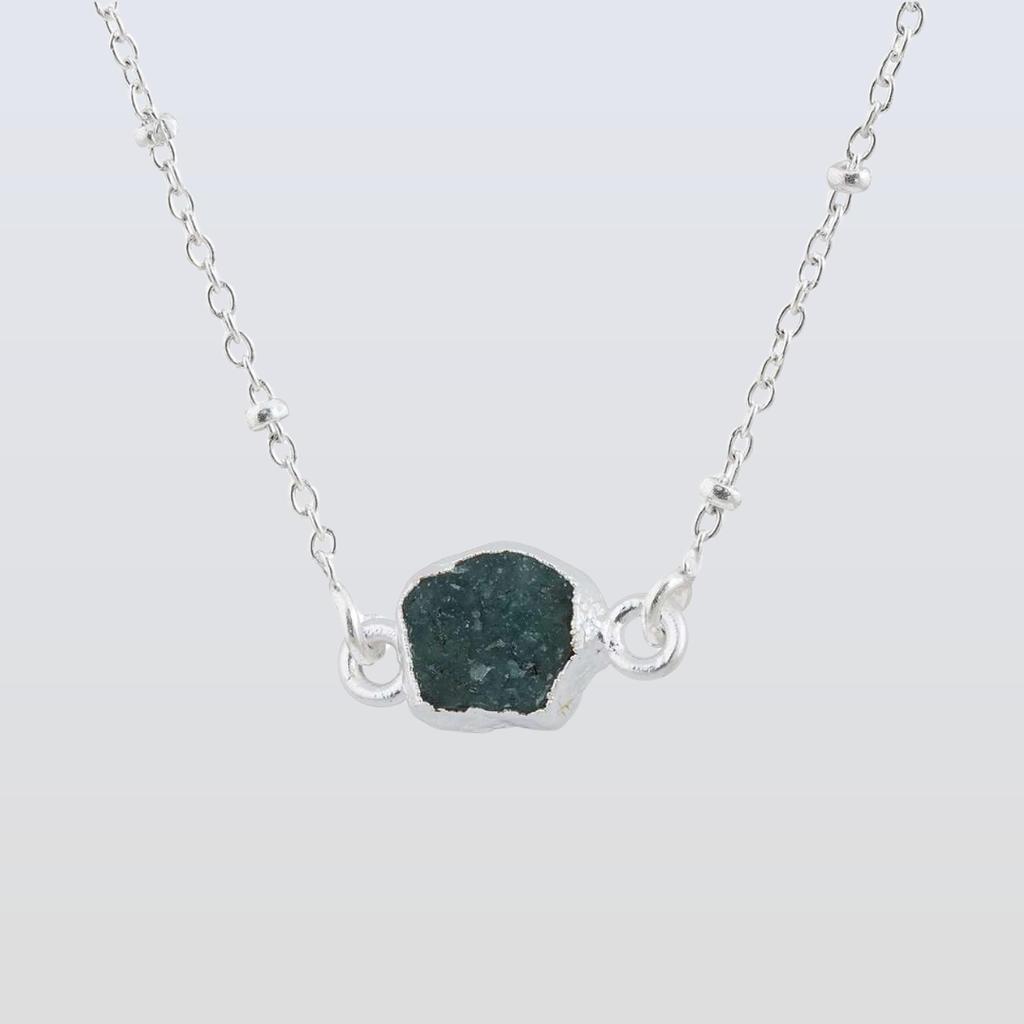 Rose gold necklace with a unique pendant on a white background