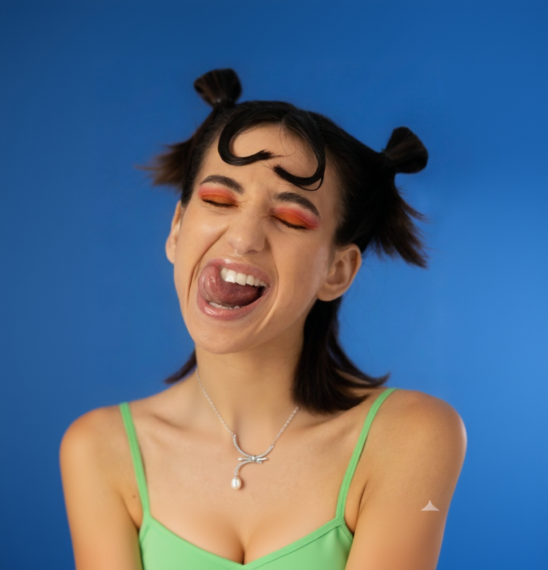 Person with styled hair and colorful makeup against a blue background