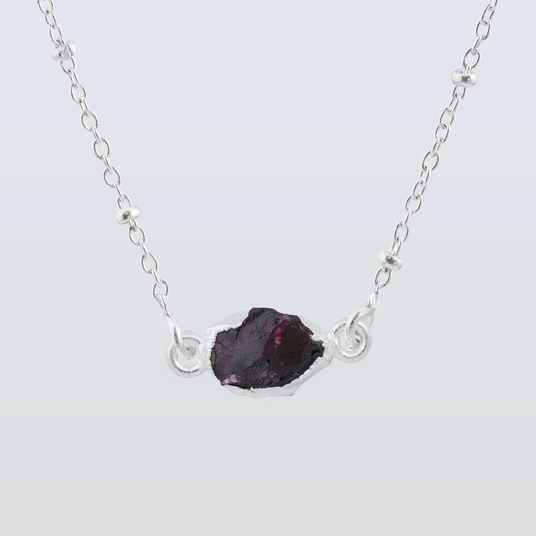 Necklace with a dark purple gemstone on a light gray background Garnet Pendants in 925 Silver