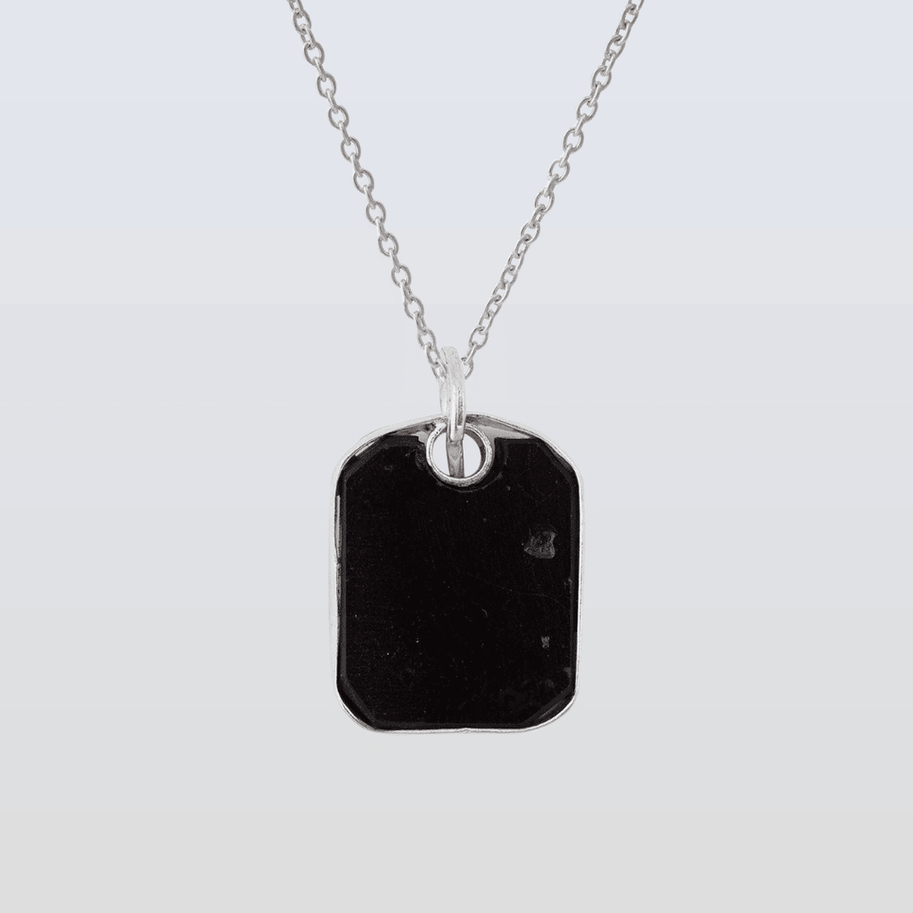 Necklace with a black pendant on a light gray background
