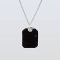 Necklace with a black pendant on a light gray background