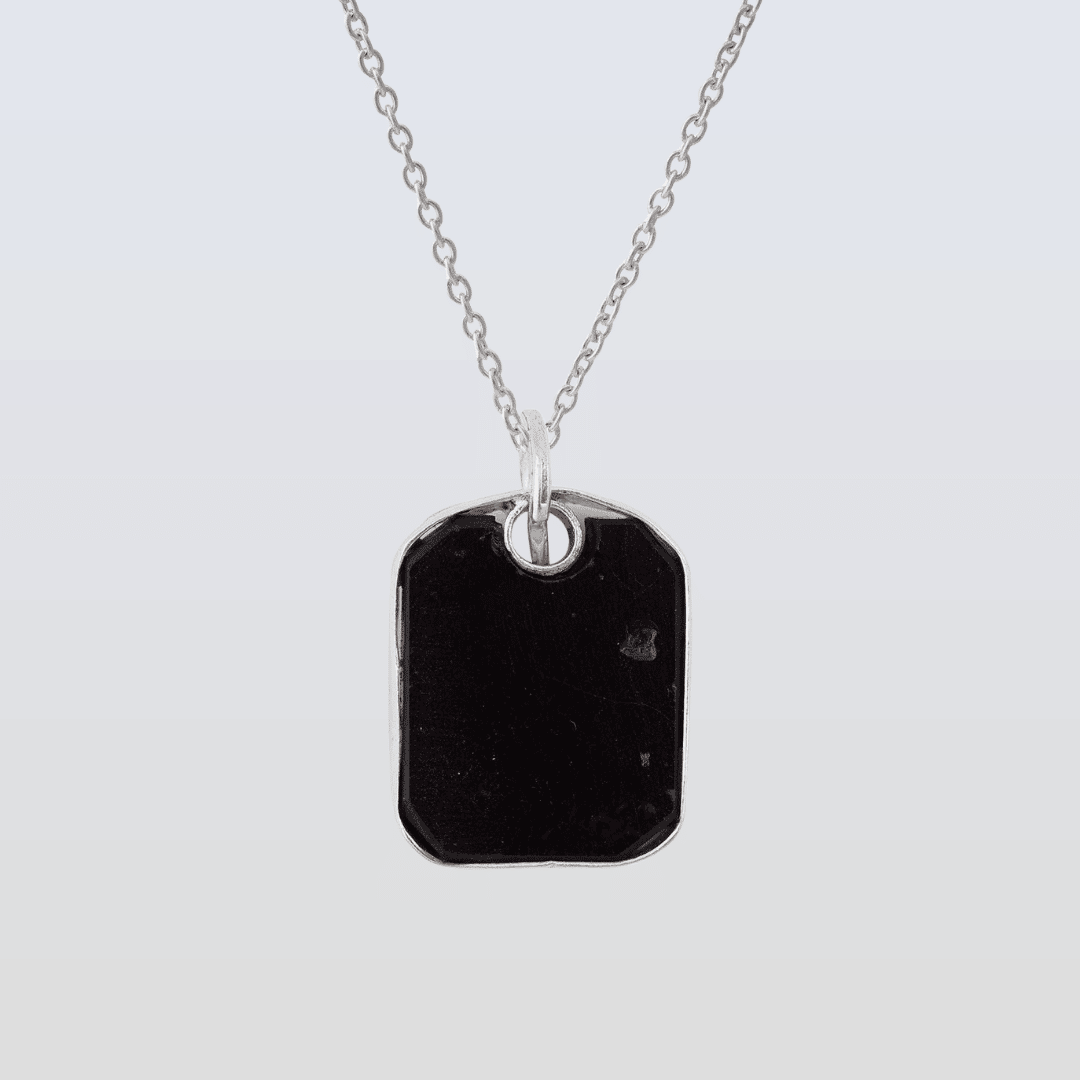 Necklace with a black pendant on a light gray background