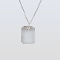 Silver necklace with a rectangular pendant on a light gray background