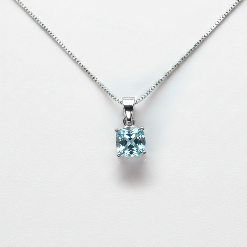 Silver necklace with a square blue gemstone pendant on a white background