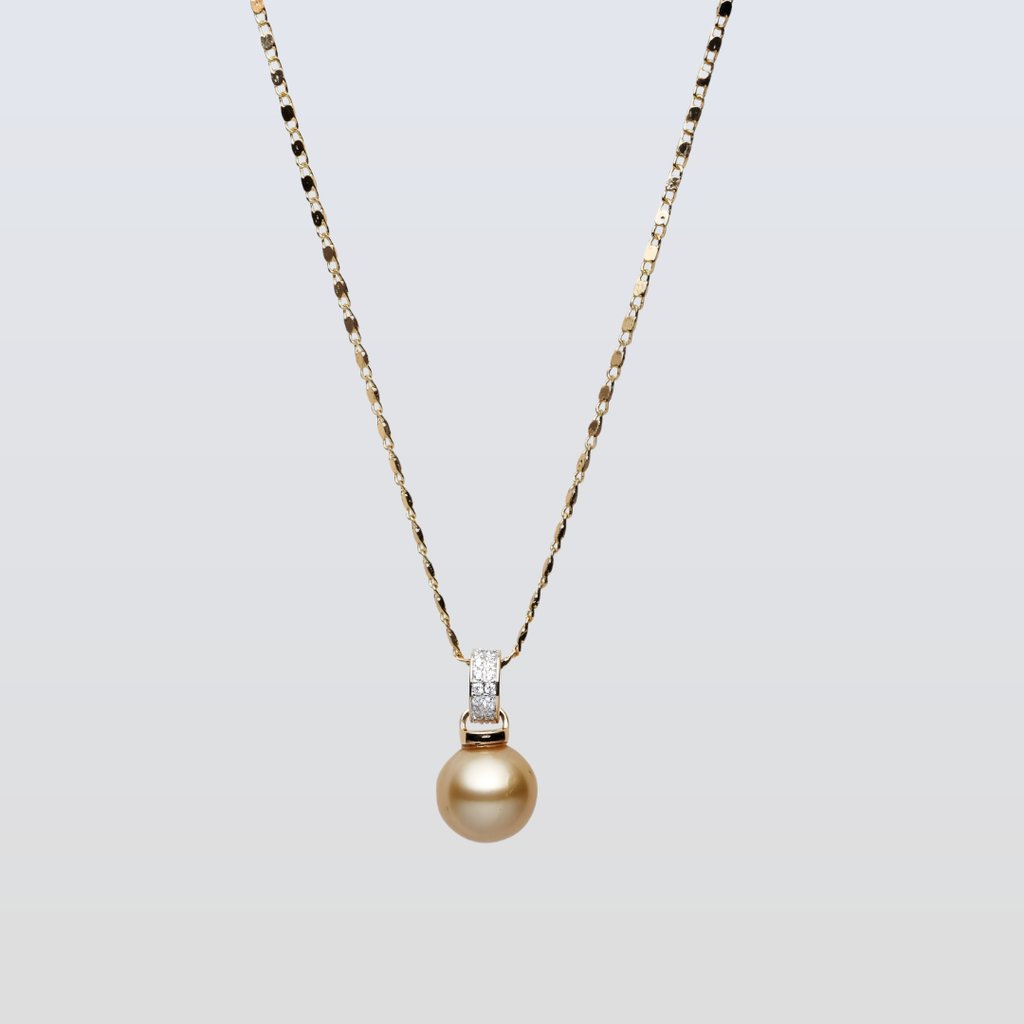 Gold necklace with a pearl pendant on a light gray background