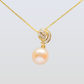 Pearl pendant with gold chain on a light gray background