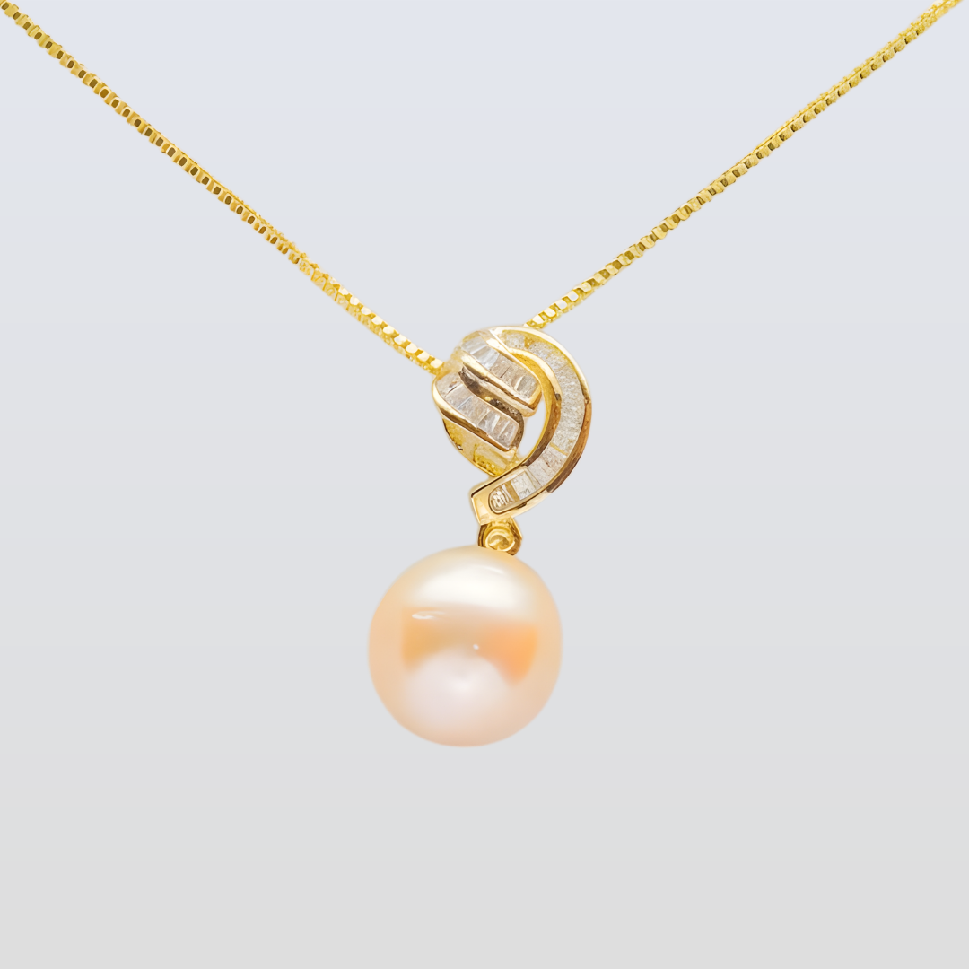 Pearl pendant with gold chain on a light gray background