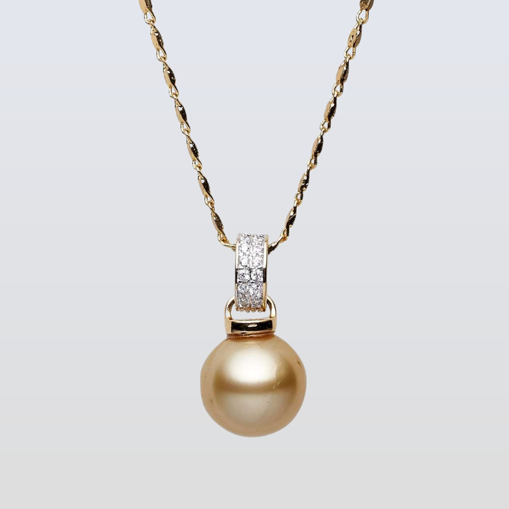 Gold pearl necklace with diamond pendant on a light gray background
