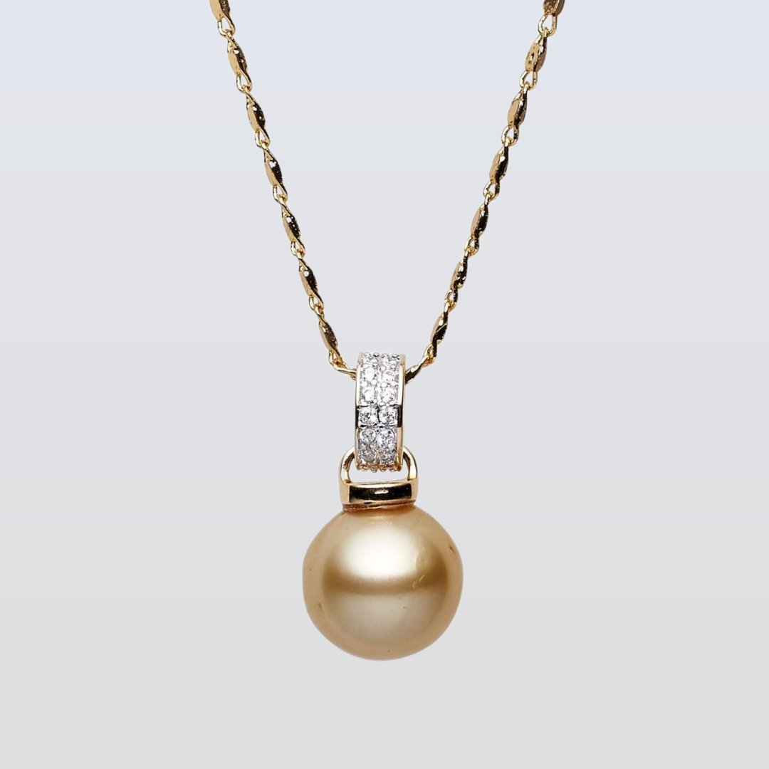 Gold pearl necklace with diamond pendant on a light gray background