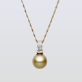 Gold necklace with a gold pearl pendant on a light gray background