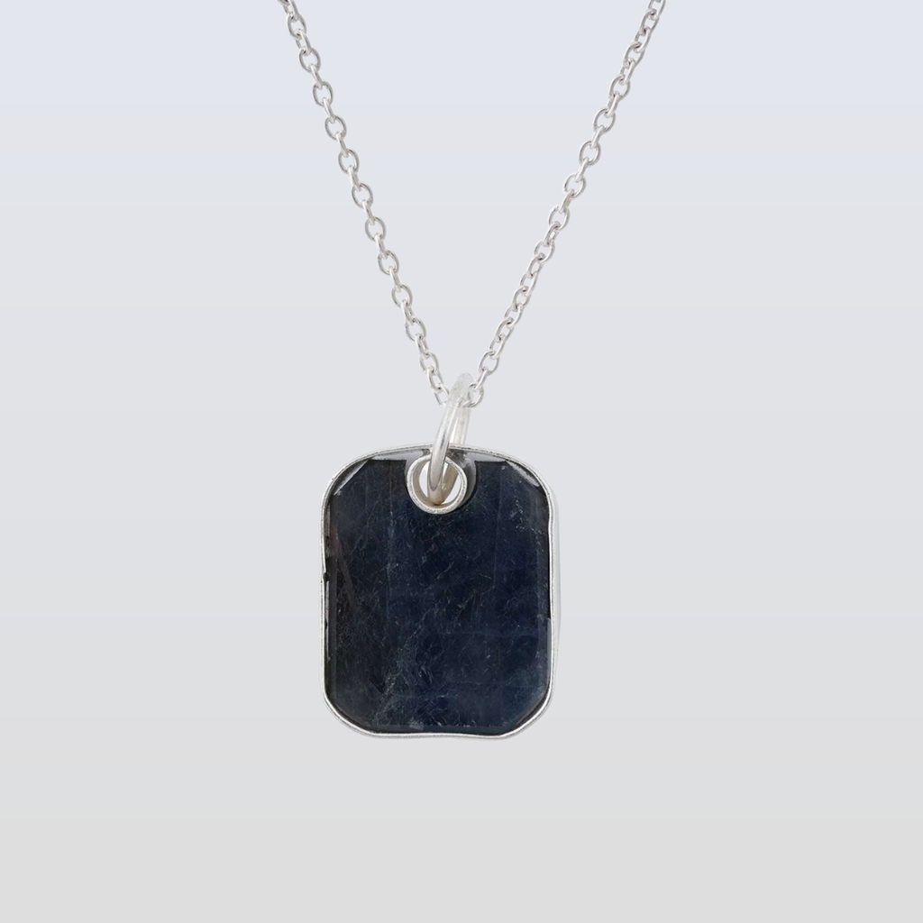 Necklace with a dark stone pendant on a light gray background