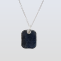 Necklace with a dark stone pendant on a light gray background