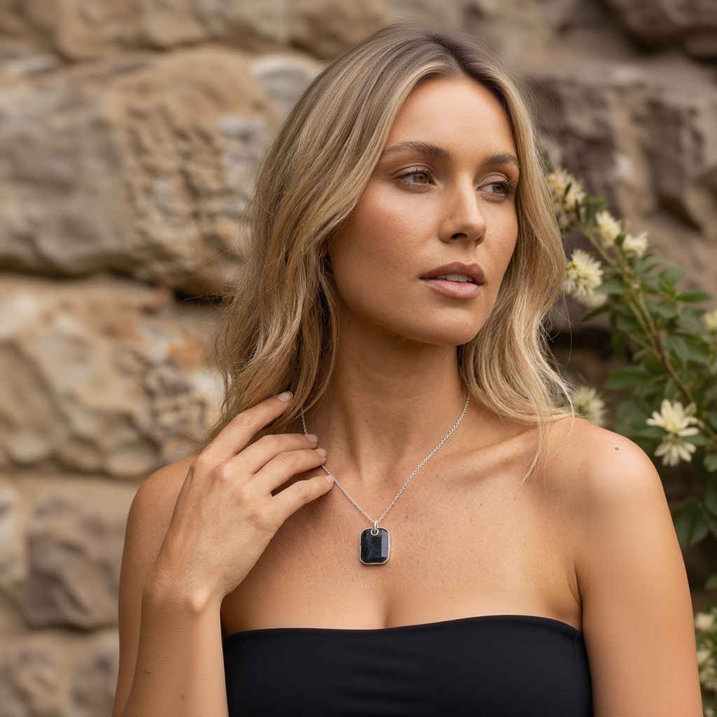 model wore Necklace with a dark stone pendant on a light gray background