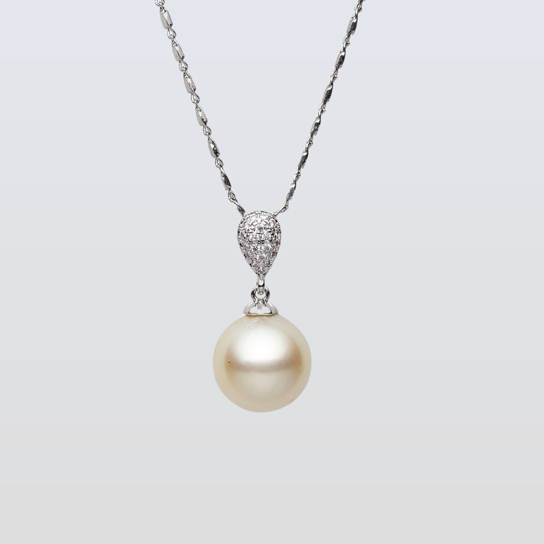 Pearl necklace with a silver chain on a light gray background