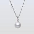 Pearl necklace with silver chain on a light gray background