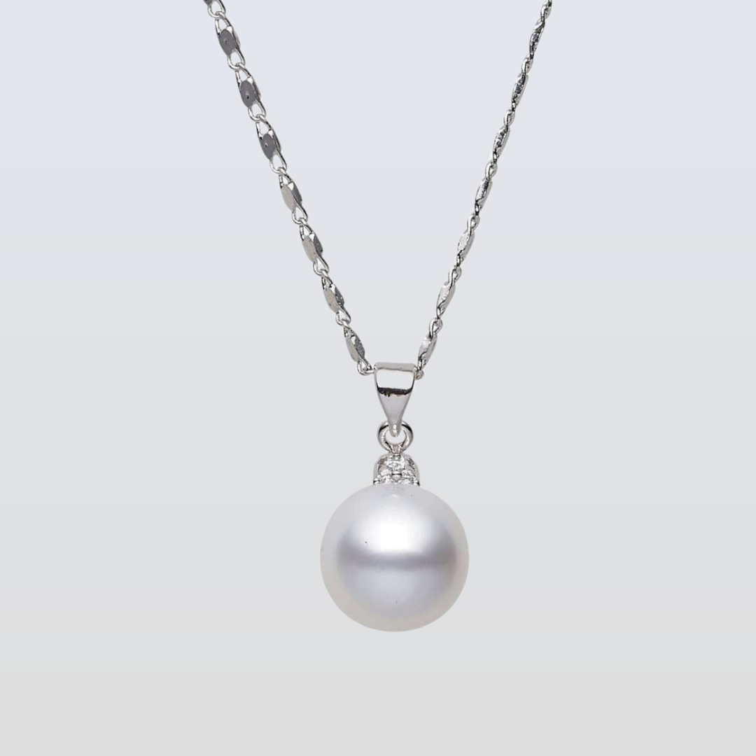 Pearl necklace with silver chain on a light gray background