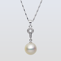 Pearl necklace with silver chain on a light gray background