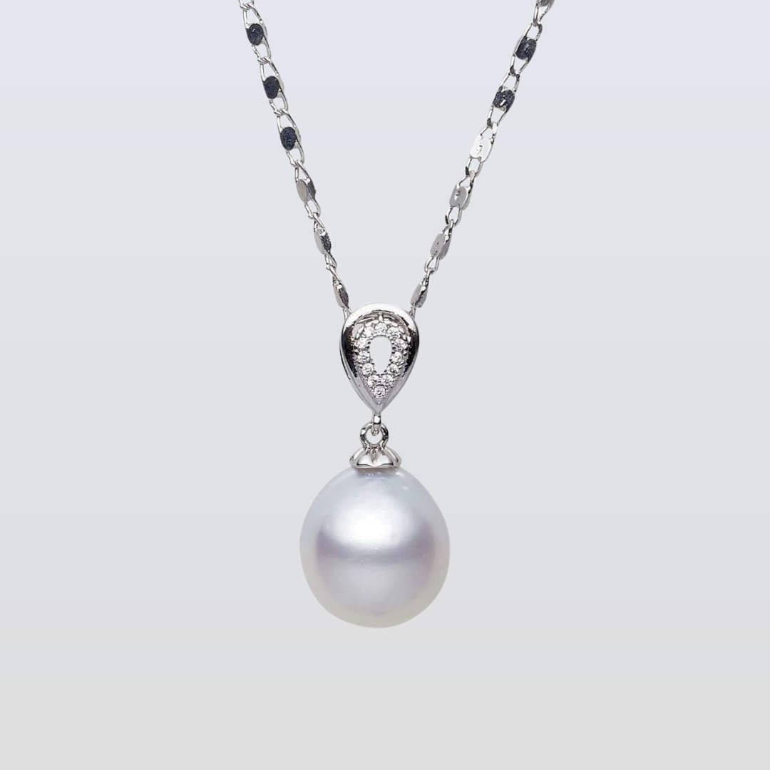 Pearl necklace with a silver chain on a light gray background