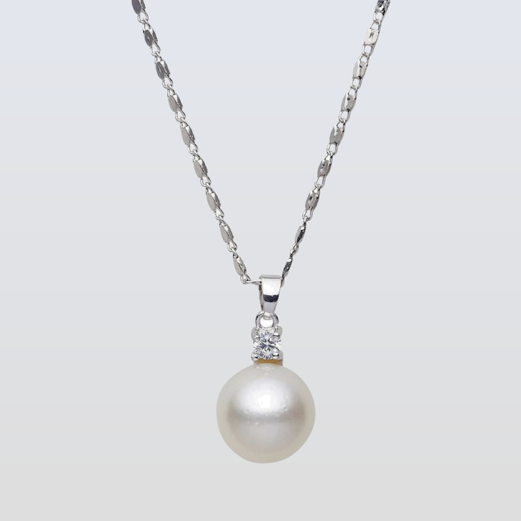 Pearl necklace with a silver chain on a light gray background