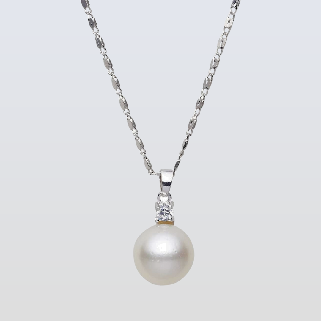 Pearl necklace with a silver chain on a light gray background