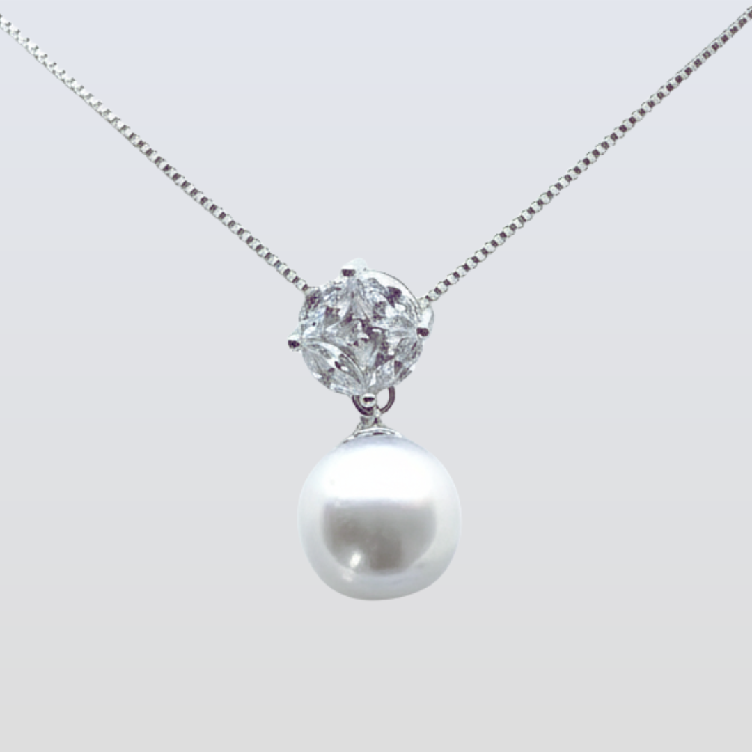 Pearl and diamond necklace on a light gray background