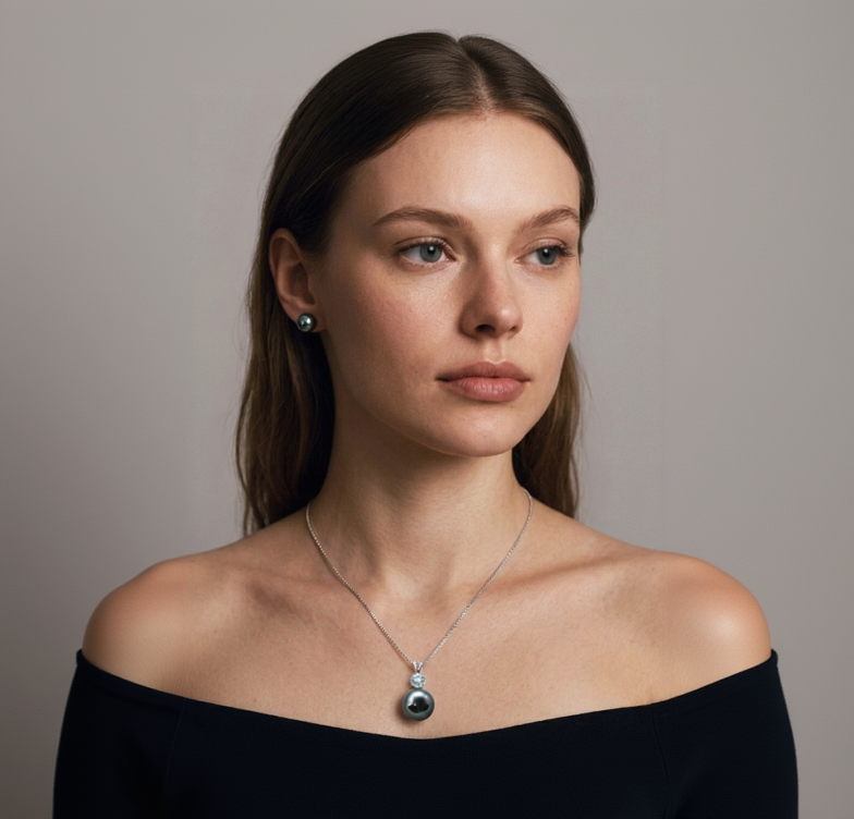 Woman wearing a necklace with a pendant against a neutral background