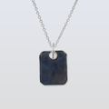 Necklace with a dark blue rectangular pendant on a light gray background