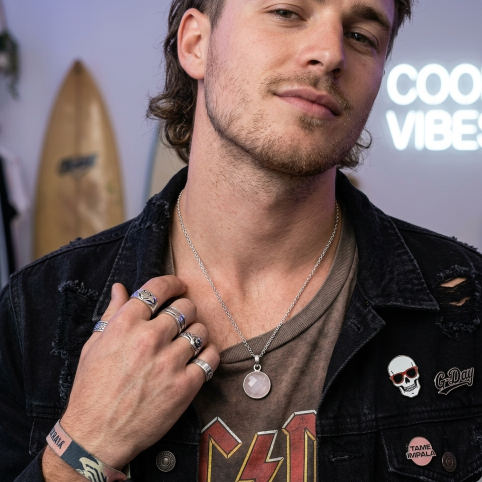 Man wearing a necklace with a 'Cool Vibes' sign in the background
