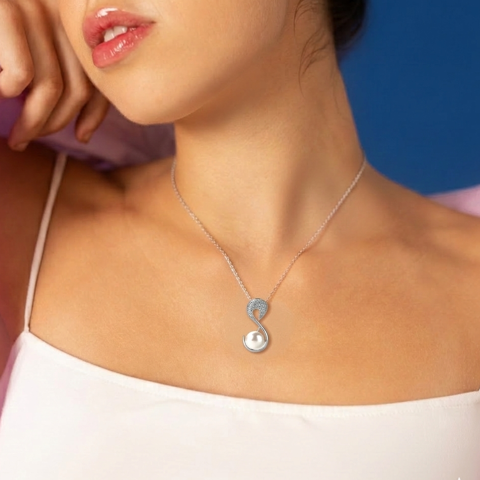 Necklace with a pendant worn by a person against a blue background