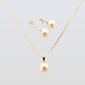 Gold necklace and earrings set on a light gray background