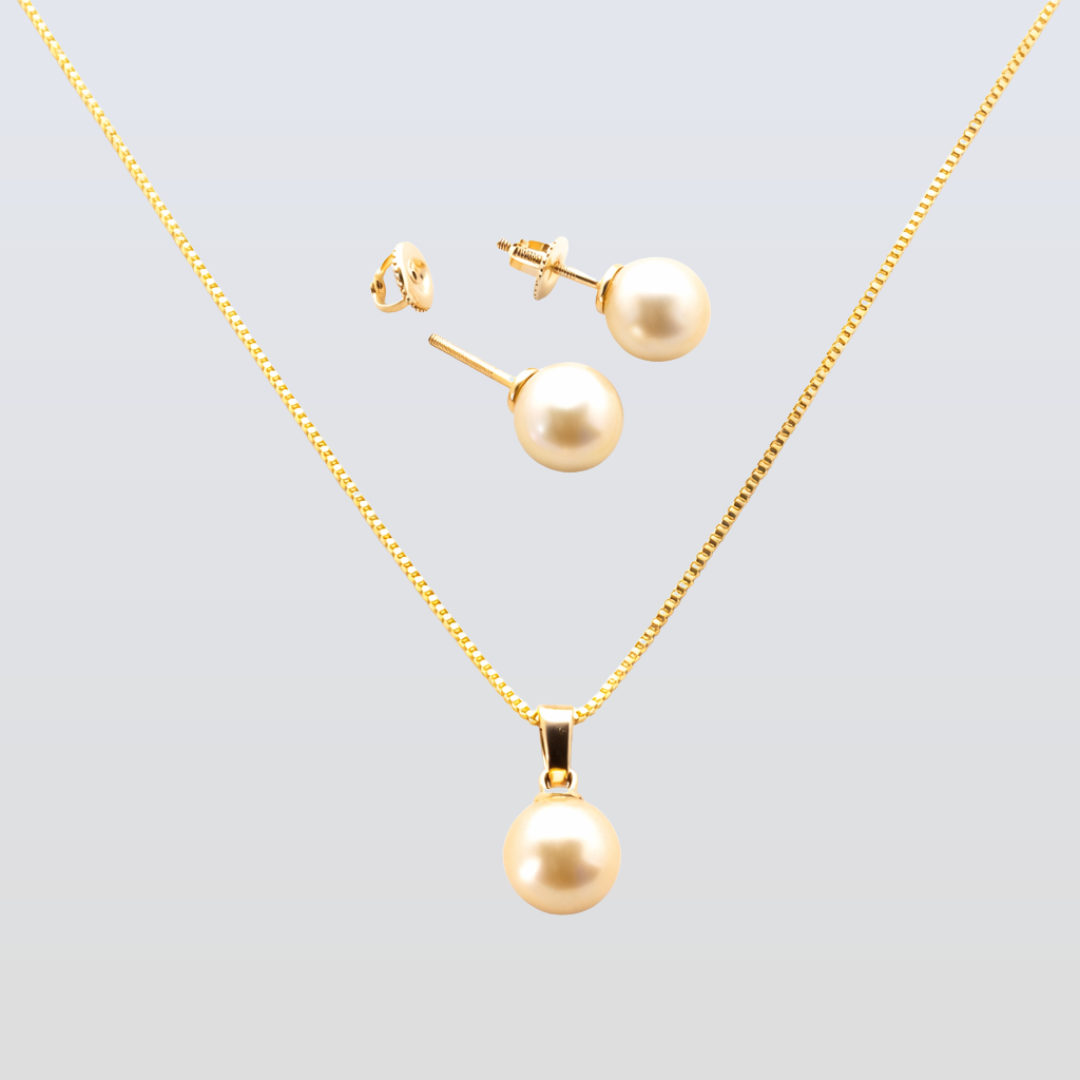 Gold necklace and earrings set on a light gray background