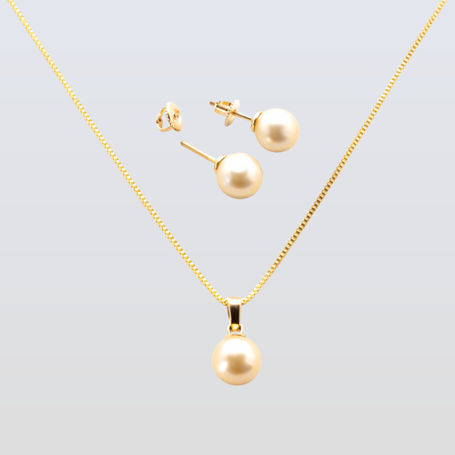 Gold necklace and earrings set on a light gray background