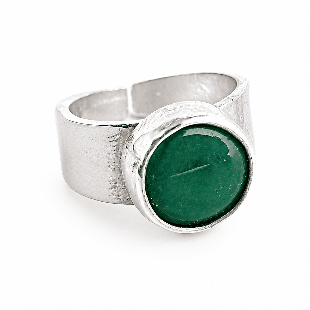 Silver ring with a green stone on a white background