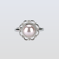 Silver ring with a pearl on a light gray background