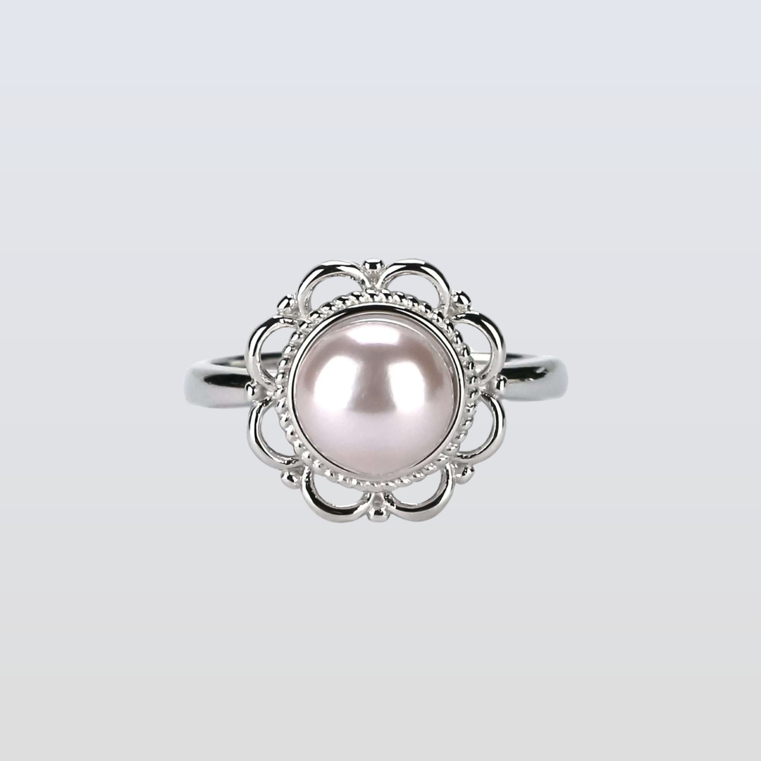 Silver ring with a pearl on a light gray background