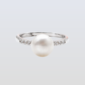 Pearl ring with a silver band on a light gray background