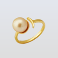 Gold ring with a pearl on a light gray background