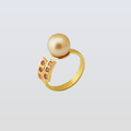 Gold ring with a pearl and pink gemstones on a light gray background