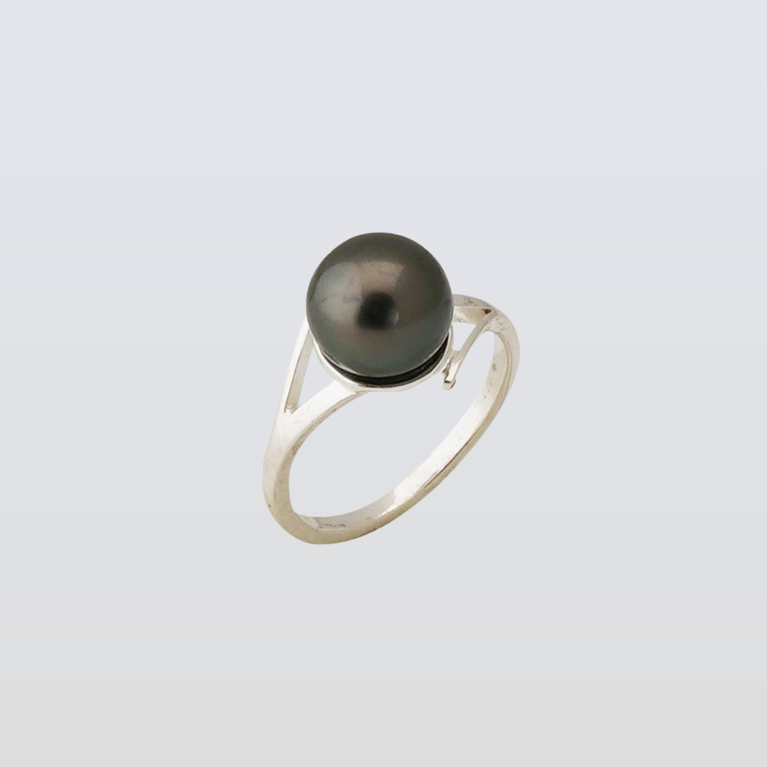Silver ring with a black pearl on a light gray background